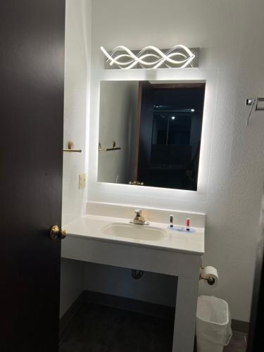 a bathroom with a sink and a mirror at Days Inn by Wyndham Jamestown in Jamestown