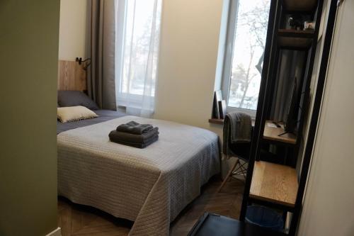 a bedroom with a bed with two towels on it at Platforma2b eco in Šiauliai