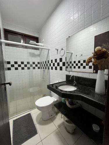 a bathroom with a toilet and a sink and a shower at Casa Praia do Frances in Marechal Deodoro