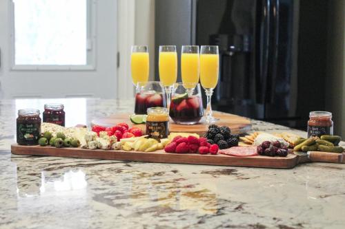 a table with two glasses of orange juice and food at Cheerful 5-bedroom w/Screened Patio, Sleeps 10 in the heart of Fremont! in Fremont