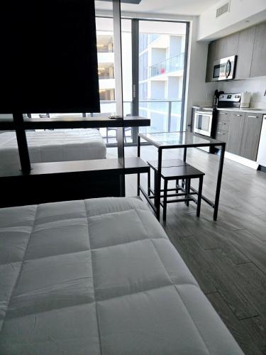 a living room with a bed and a table and a couch at Miami Myami Miamí Studio Apartment with Balcony in Miami
