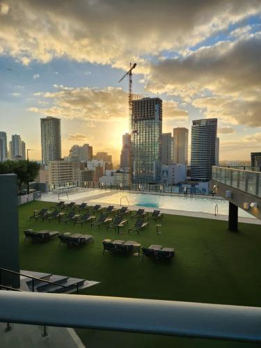 a group of tables and chairs on the roof of a building at Miami Myami Miamí Studio Apartment with Balcony in Miami