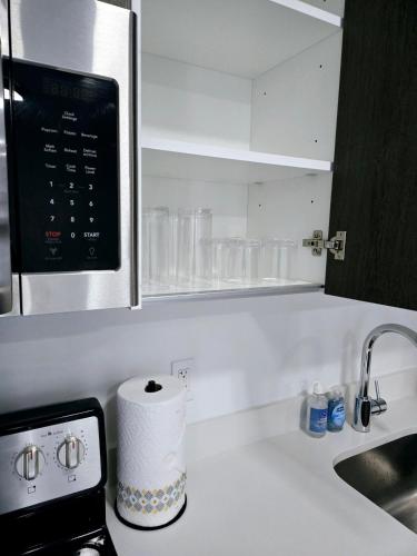 a kitchen counter with a sink and a roll of paper towels at Miami Myami Miamí Studio Apartment with Balcony in Miami