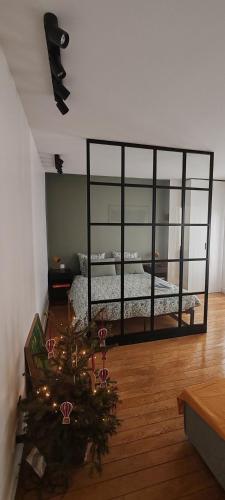a bedroom with a bed with a large glass window at Studio moderno al centro di Parigi - République in Paris