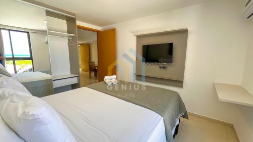 a hotel room with a bed and a tv at Eco Summer Tambaú WB Genius Flats in João Pessoa