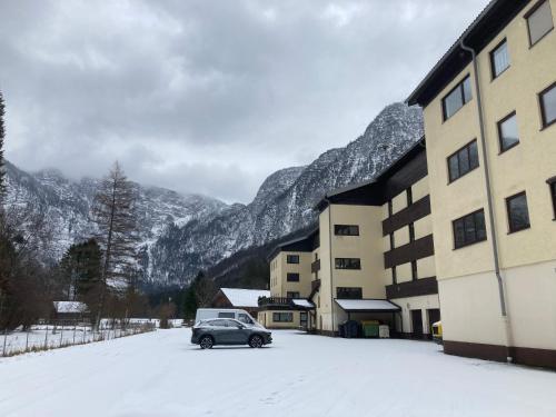 a car parked in the snow next to a building at Apartment Elisabeth in Obertraun
