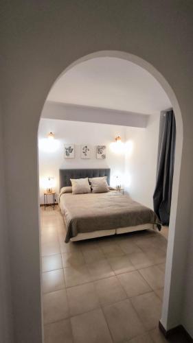 a bedroom with a large bed with an archway at El Mirador dels Ports in Paúls