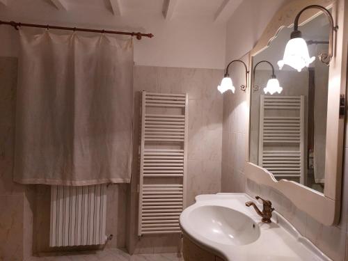 a bathroom with a sink and a toilet and a mirror at Agriturismo Terre di Anghiari in Anghiari
