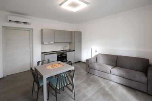 a living room with a couch and a table and chairs at Agriturismo Villa San Marco in Montefelcino