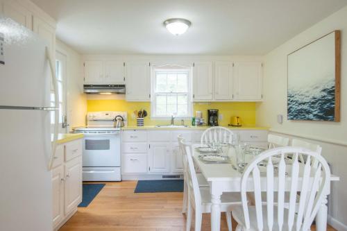 a kitchen with white cabinets and a white table and chairs at Huge Deck Outdoor Shower Dog Friendly in Brewster