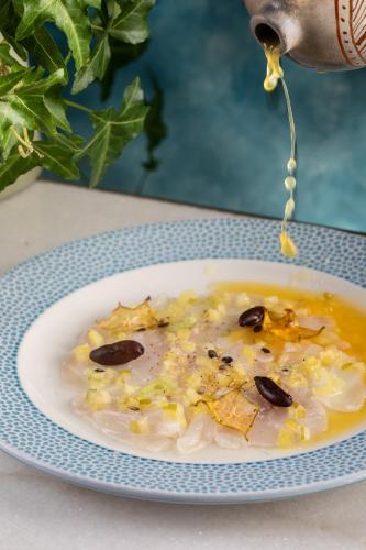 a plate of food on a table with a bowl of soup at Fairmont Rio de Janeiro Copacabana in Rio de Janeiro