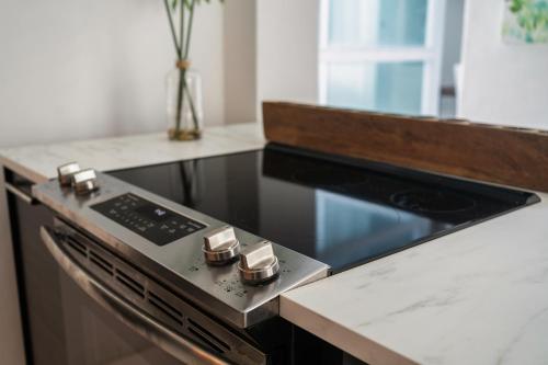 a kitchen with a stove and a counter top at Spanish Penthouse Historic Mansion Private Patio in San Juan
