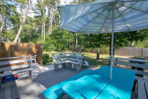 a picnic table and an umbrella on a deck at Peace and Quiet & Spacious Back Deck in Wellfleet