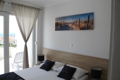 sypialnia z łóżkiem i dużym oknem w obiekcie Apartment Villa Lumada with Pool w Novalji