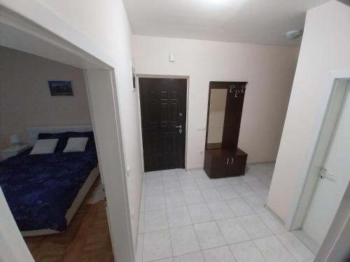 a bedroom with a bed and a door to a closet at Sorin Apartments Gevgelija in Gevgelija