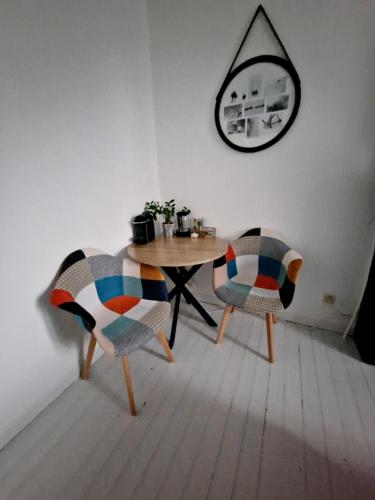 a dining room with a table and two chairs at ULALA CHARLEROI AIRPORT Bruxelles in Pont-à-Celles