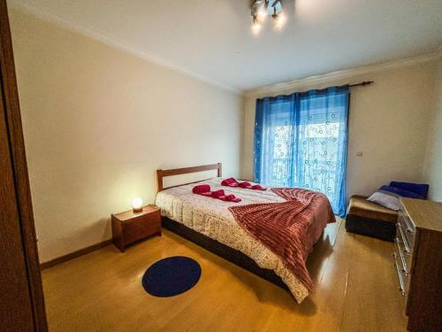 a bedroom with a bed and a window at Family holiday home new beds in Bragança