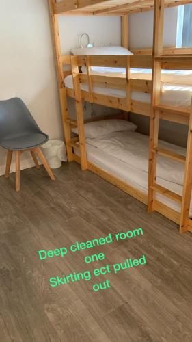 a room with two bunk beds and a chair at Matrix Hostel in Edinburgh