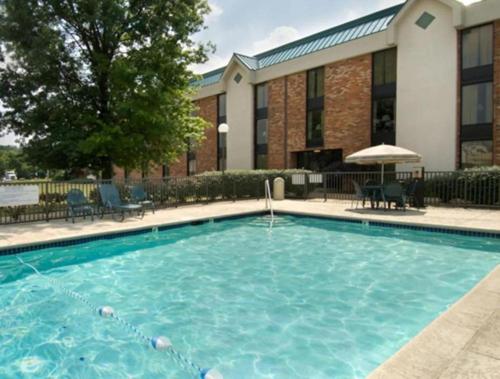 a large swimming pool in front of a building at Wingate by Wyndham St Louis-Fenton Route 66 in Fenton