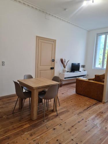 un salon avec une table et des chaises en bois dans l'établissement Jérémy, à Rochefort