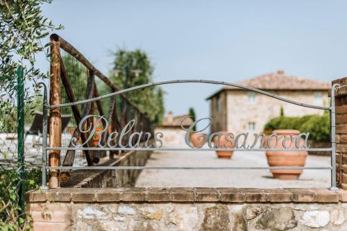 a metal gate with a welcome sign on a bridge at Relais Casanova in San Gusmè