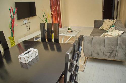 a living room with a table and a couch at Urban Oasis in Kakamega