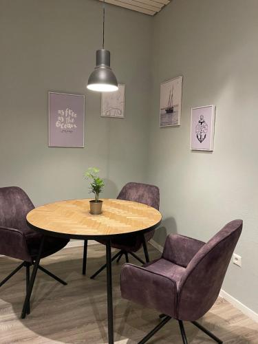 a dining room with a table and purple chairs at Unique loft for 8 in Eggenstein-Leopoldshafen