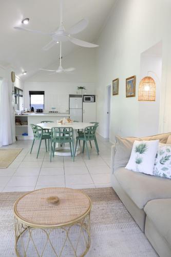 a living room with a couch and a table at Makayla Palms in Rarotonga