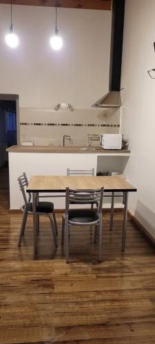 a kitchen with a table and two chairs and a counter at Elved in Esquel