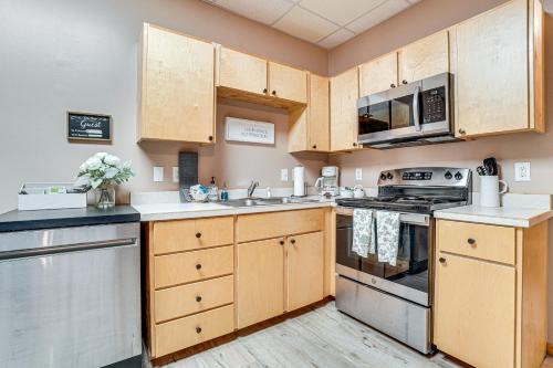 a kitchen with wooden cabinets and stainless steel appliances at Spacious Home in Helen with Porch and Balcony! in Helen