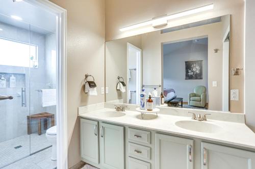 a bathroom with two sinks and a large mirror at Furnished Deck, Mountain View Castle Rock Home! in Castle Rock