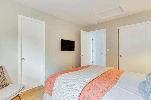 a bedroom with a bed and a tv on the wall at Furnished Deck, Mountain View Castle Rock Home! in Castle Rock