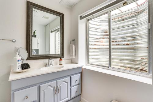 a bathroom with a sink and a window at Furnished Deck, Mountain View Castle Rock Home! in Castle Rock