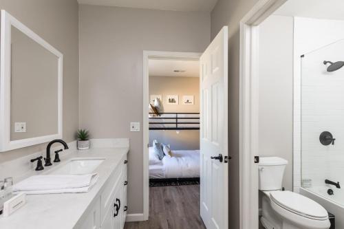 a white bathroom with a sink and a toilet at Sereno - Sparkling Pool - Near Scottsdale Quarter in Phoenix