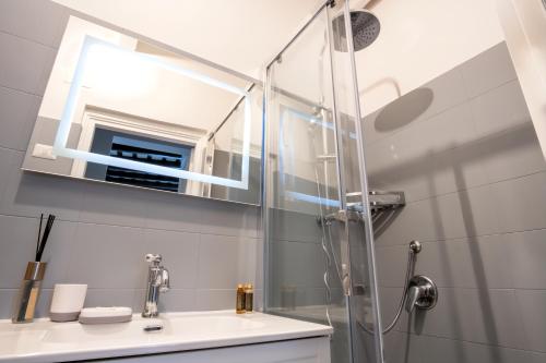a bathroom with a sink and a shower at Elegantis Trevi Suite Apartment - Just 50m from Trevi Fountain in Rome
