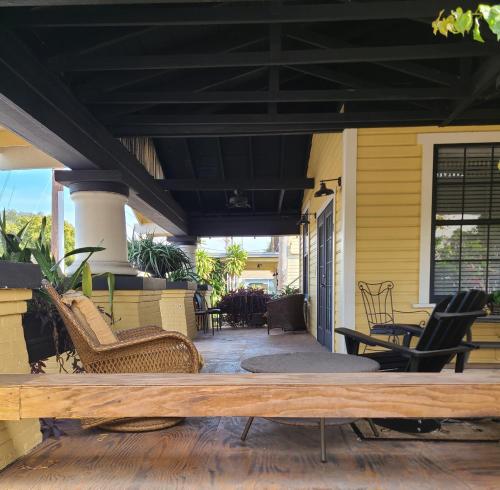 a patio with chairs and a black roof at Palm Villa Hostel in Tampa