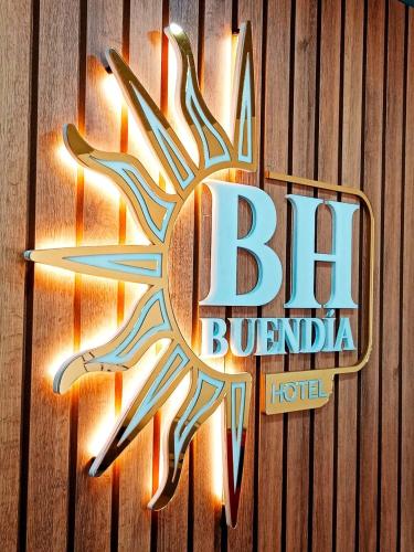 a sign for a berk buffalo hotel on a wooden wall at Buendía Hotel in Barrancabermeja