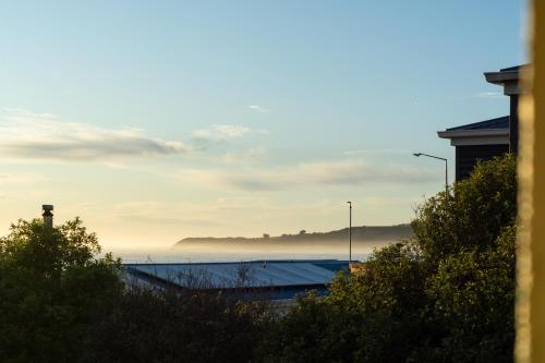 a view of the ocean with fog in the distance at Comfortable Spacious Home, Close to Beach in Kaikoura