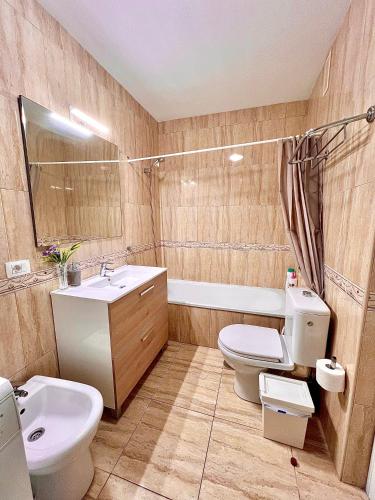 a bathroom with a white toilet and a sink at Apartamento Primavera I in Palm-Mar
