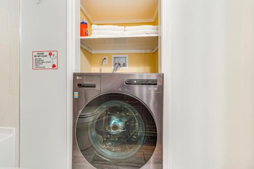 a washing machine in a laundry room with a sink at 4 Mi to Hudson River Cozy Newburgh Home! in Newburgh