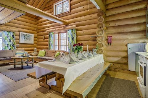 a dining room with a table in a log cabin at VIP Rakka Villas 7 & 8 in Levi