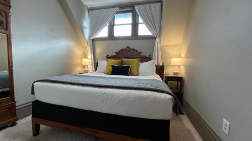 a bedroom with a large bed with a window at Stone Gables Inn in Cleveland