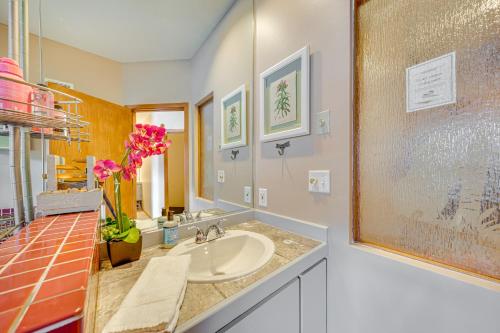 a bathroom with a sink and a mirror at Steps to River Run Gondola Ski Condo with Views! in Keystone