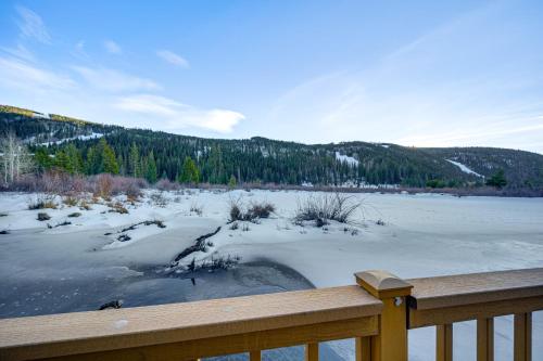 a view of a frozen lake with snow and trees at Steps to River Run Gondola Ski Condo with Views! in Keystone