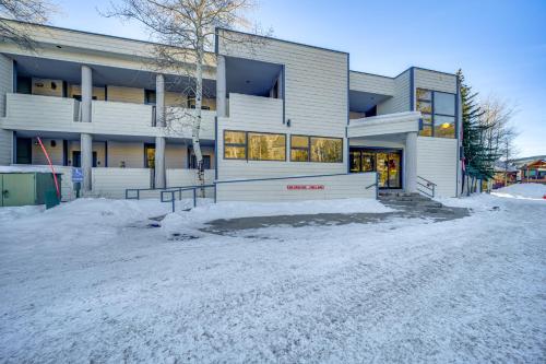a building with snow in front of it at Steps to River Run Gondola Ski Condo with Views! in Keystone