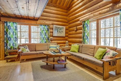 a living room with a couch and a table at VIP Rakka Villas 7 & 8 in Levi