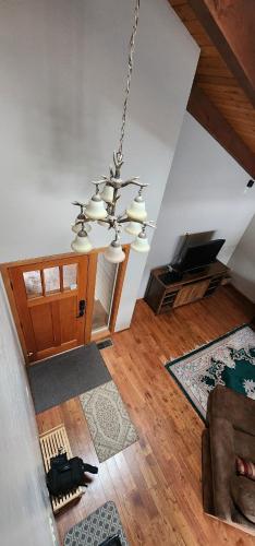 a living room with a chandelier hanging from the ceiling at Mt. Bachelor & Sun River Get Away in Bend