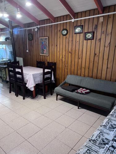 a living room with a table and a couch at Cabañas Gabella in Lago Ranco