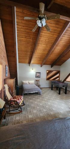a living room with a ceiling fan and a bed at Mt. Bachelor & Sun River Get Away in Bend