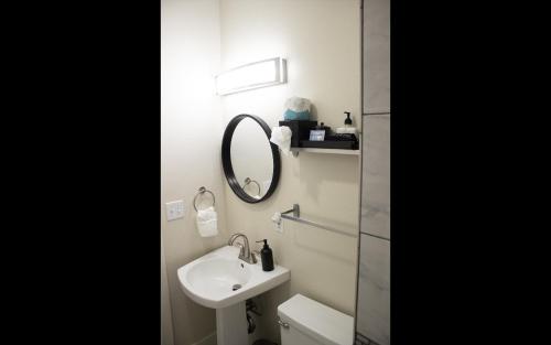 a bathroom with a sink and a mirror at Leland House Suites of Durango in Durango